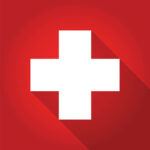 First aid symbol. White cross on red background